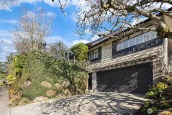 Perfectly located  in a quiet pocket just off the Magnolia Bridge, across from Magnolia Park and an easy roll or stroll to all of Magnolia Village amenities, this lovely 1955 home has incredibly gracious living spaces, and is perched high for privacy while enjoying abundant light from all sides thanks to it's corner lot.