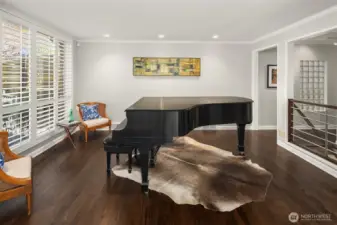 Even if you don't play piano you will appreciate this space.  Windows face north for soft/diffuse all-day light.  Stairs lead to the lower level, and the hall takes you to the dining room, kitchen, and 2 beds/1.75 baths.