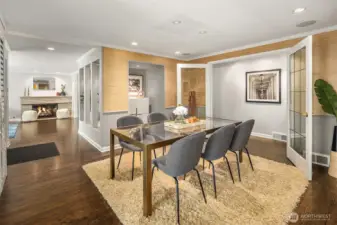 You could easily fit 8-10 in the dining room, with the French Doors closed and the right table/chair configuration.  The deep cut-out with lighting is a perfect spot for a bar cart.