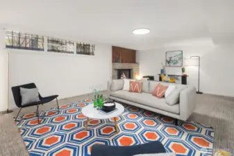 The lower level family room has nice ceiling height and loads of space, and features a gas fireplace with original midcentury stone surround and cool wood detailing above the mantle.