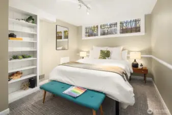 The lower level 3rd bedroom is non-conforming due to the current window size and height from the ground; but has nice ceiling height, a built-in bookcase, and closet (just out of frame on the left.)