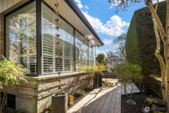 An Ipe wood walkway leads from the top of the front entry stairs to the front patio.