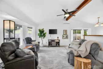 Light filled open concept living area w/ charming bay window
