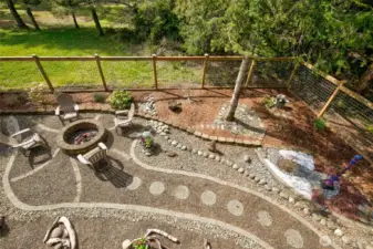 Back yard fire pit is a lovely gathering space for evening bonfires and socializing.