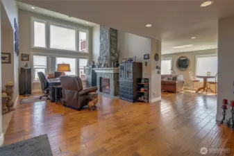 Great room faces the front of the home with bay and mountain views, and two-way stone fireplace.