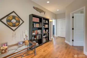 At the top of the stairs, you are greeted by a spacious hallway to the primary suite, two bedrooms, a full bath, and large linen closet.