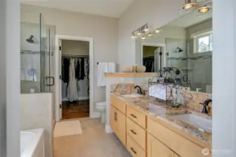 Dual vanity sinks with granite countertops and new fixtures round out the bathroom.