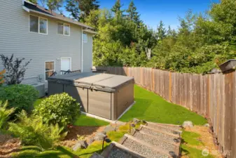 Expansive back yard w/ outdoor kitchen, multiple entertaining areas, Swim Spa & garden beds