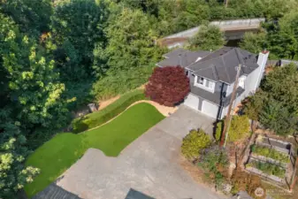 Expansive back yard w/ outdoor kitchen, multiple entertaining areas, Swim Spa & garden beds