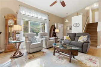 Living room window frames tranquil views of the water feature and lush landscaping.