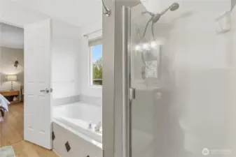 Primary bathroom offers a soaking tub and separate shower for everyday comfort