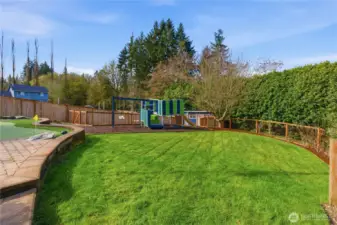 Flat, lush grassy area with a playset—perfect for play and enjoying the outdoors