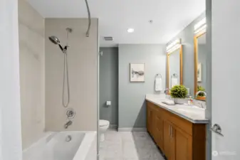 The bathroom features a dual vanity with marble counters and floor. The six foot soaker tub is perfect for relaxing after a long bike ride.