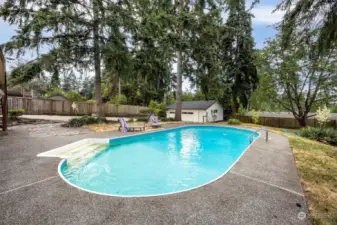 This home has a heated pool, fire pit, & oversized 2 car garage with shop area