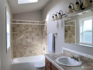 Second bathroom with bathtub and skylights