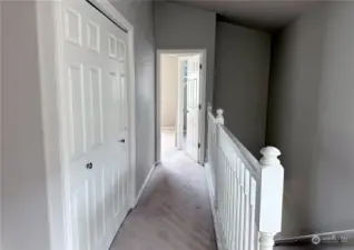 Hallway to master bedroom. Laundry in closet