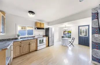 With its open concept design, this photo showcases how the kitchen connects effortlessly with the dining area, creating a cohesive living space that’s perfect for modern living. Note the decorative touches like built-in shelves and cabinetry.