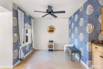 A closer look at the living room reveals elegant design elements, including a decorative wall mirror and charming curtains. The space is thoughtfully laid out, offering potential for various furniture arrangements.