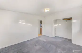 This angle showcases the bedroom’s functional design, complete with an open closet for easy access and a seamless connection to the rest of the home. The clean lines and bright walls offer a fresh canvas to make the space your own.