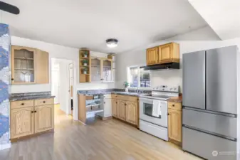 The heart of the home, this bright kitchen offers a thoughtful layout with abundant storage and counter space. Large windows bring in natural light, creating an inviting space for cooking and gathering.