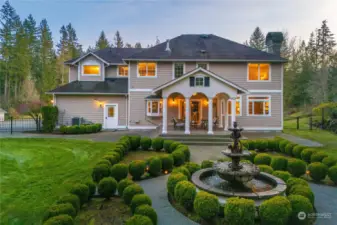 Step outside French doors to a large covered patio  with a distinctive wood columned design: sip a cool  beverage on a hot day as you look out over the  manicured grounds and water fountain – you’ll think  you were in Italy from this beautiful vantage!