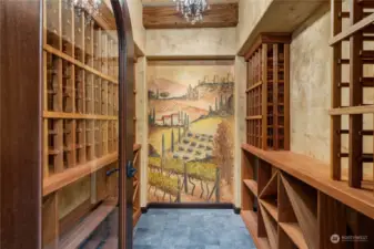 ! For the wine enthusiast, a stunning  custom wine cellar with a hand-painted fresco by artist  Carla Morrison can hold numerous bottles and host a wine  tasting.