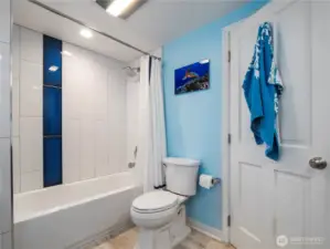 Main floor bathroom with a tiled bath surround