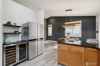 Featuring a new stainless steel fridge and wine cooler, plus additional shelving, this stylish nook is ready for a wine or coffee bar.