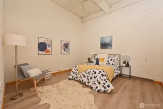 Large master bedroom with 12 ft ceiling and fan