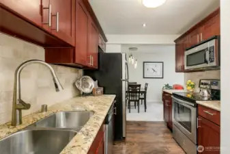 Cherry colored cabinetry beautiful granite counters