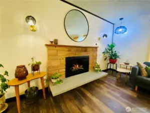 Original brick fireplace with stone slab seating in front.