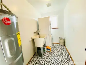 Oversized laundry room with large tub sink. Plenty of room to add shelves or larger washer/dryer! The current appliances all stay with the house.
