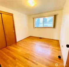 Large extra guest bedrooms/office space with double closet and original hardwood floors.