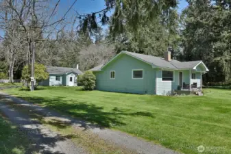 main home with detatched garage/shop in background