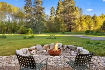 Enjoy sitting by the fire while taking in the beauty of the back yard.