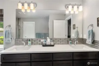 Double vanity in the primary bath, with granite counters.