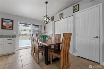 Dining space and kitchen with walk-out to backyard oasis