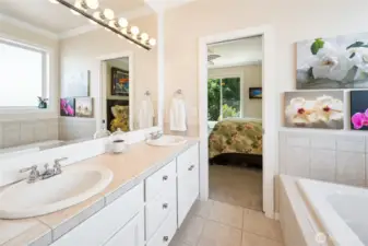 Primary bath offers a 5-piece layout with tub, shower & dual sinks.