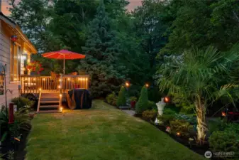 The backyard beauty enhanced by its lush natural backdrop.