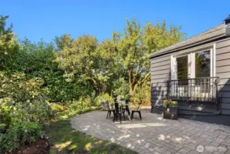 Lovely oversized wrap around patio. French doors from primary bedroom overlooking the patio and lush landscaping.