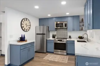 Stylish Kitchen with Stainless Appliances & Quartz Counter tops.