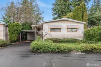 Front of home with beautiful trees surrounding