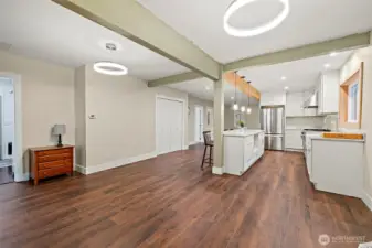 Looking back into the home from the dining room. Gleaming LVP flooring, great paint accents and beams! Such style and comfort!