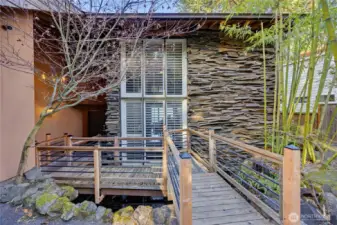 Unique entry walkway crossing the tranquil koi pond.