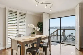 Dining area looks out to the water and has sliding doors for easy access to the deck.
