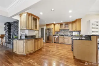 Kitchen with granite countertops and stainless steel appliances, custom tile backsplash and tons of storage!