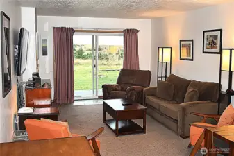 Step right out into the dunes from this comfy great room