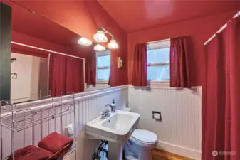 This lovely bathroom with wainscoting and pedestal sink!