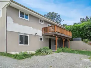 Rear of home with new deck and repair of stucco where the previous deck was located.  Seller to paint prior to closing.