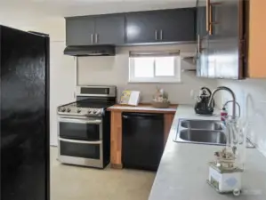 View of kitchen from hallway (virtually staged).